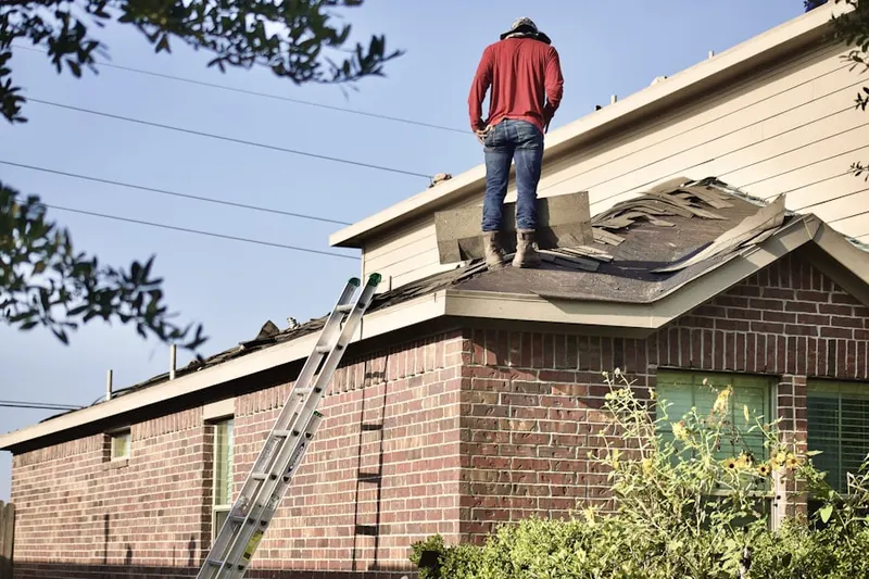 Professional roofer working on a residential roof in Central Perris